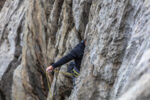 A man sport climbing