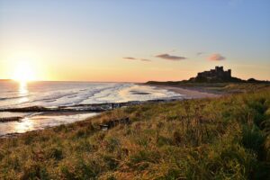 Bamburgh coastline in Northumberland with the sun rising